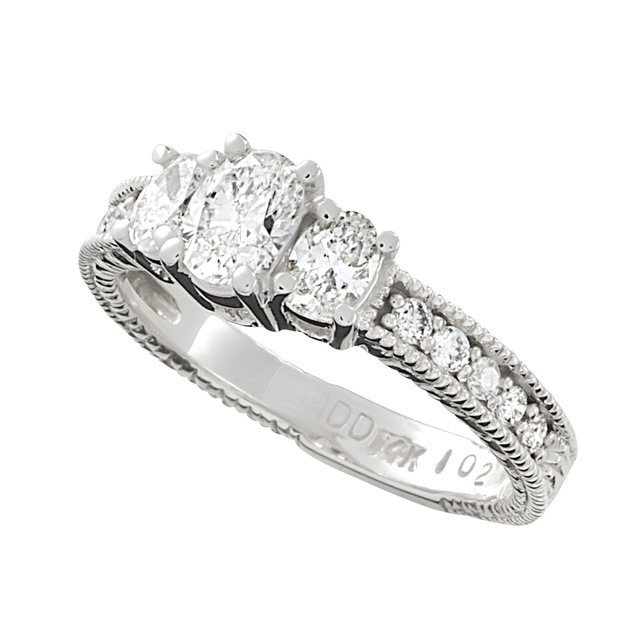 Three Stone Oval Diamond Ring With Side Diamonds And Engraving With Lucida/Trellis Prongs